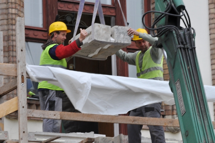 Kőfaragók dolgoznak a Városháza erkélyén
